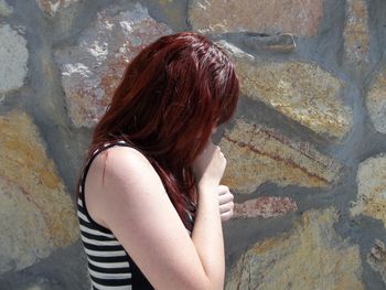 Side view of young woman standing outdoors