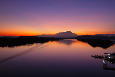 Scenic view of lake against romantic sky at sunset