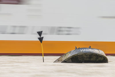 Germany, hamburg, blankenese container ship passing by uwe shipwreck