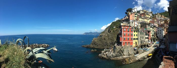 Panoramic view of sea against buildings