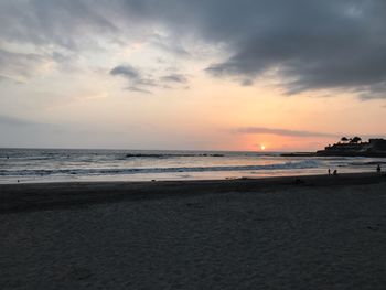 Scenic view of beach against sky during sunset