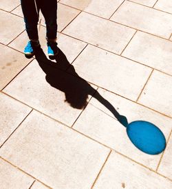 Low section of man standing on tiled floor