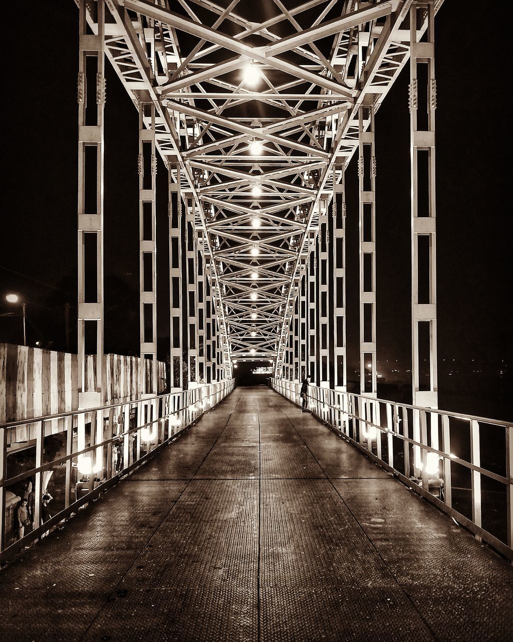 EMPTY FOOTBRIDGE IN ILLUMINATED BUILDING