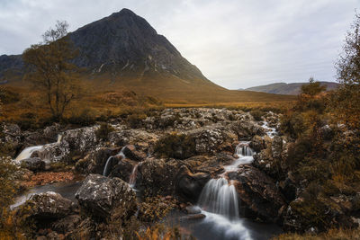 Scenic view of waterfall against sky