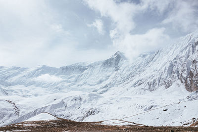 Scenic view of snowcapped mountains against sky