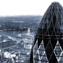 Sir norman foster building and cityscape against sky