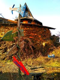 Traditional windmill on field against sky