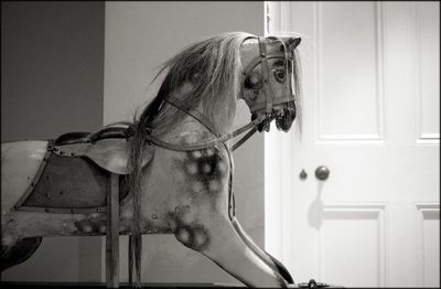 Close-up of rocking horse in house