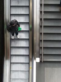 Man sitting on window of building