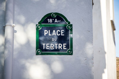 Close-up of information sign on wall