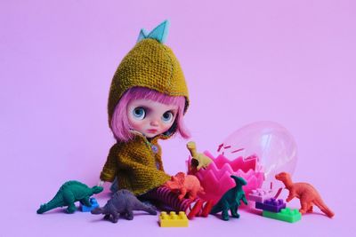 Close-up of toys against purple background