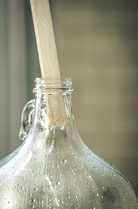 Close-up of glass bottle with drinking straw