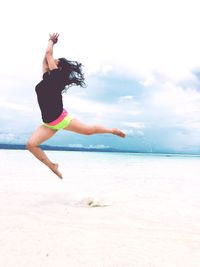 Woman jumping on beach