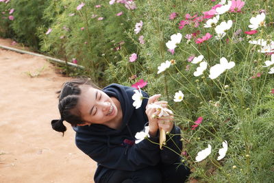 Young woman smiling in flower field