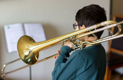 Boy holding trombone
