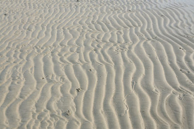 Full frame shot of tire tracks on sand