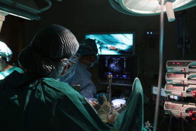 Surgeons working in operating room