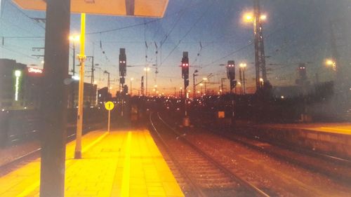 Illuminated railroad station platform at night