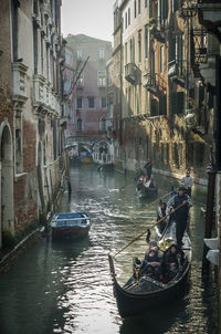 Boats in canal along buildings