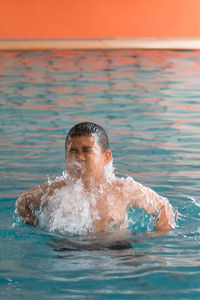 Boy swimming in pool