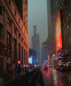 City street amidst buildings at night