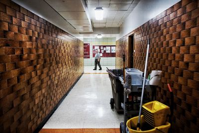 Man walking in corridor of building