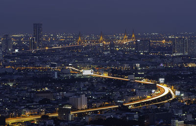 High angle view of illuminated buildings in city at night