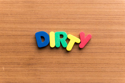 Close-up of text on wooden table