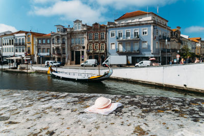 Boats moored at canal against buildings