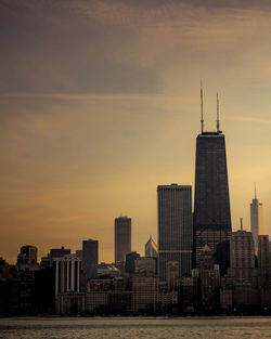 Modern buildings in city during sunset