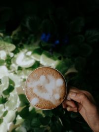 Close-up of hand holding coffee cup