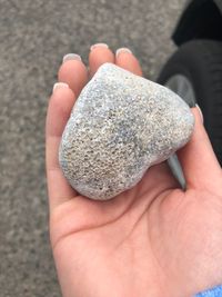 Close-up of human hand holding rock