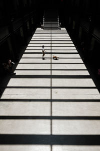 Rear view of man walking on steps