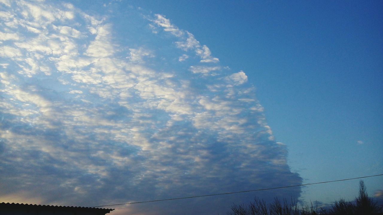 sky, low angle view, cloud - sky, silhouette, connection, tranquility, nature, blue, beauty in nature, scenics, power line, cloudy, tranquil scene, cloud, dusk, outdoors, no people, cable, day, electricity