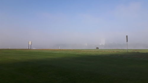 Scenic view of field against sky during foggy weather