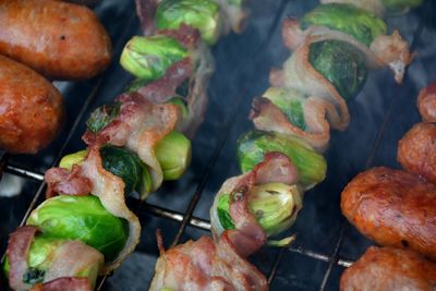 High angle view of meat and vegetables on barbecue grill