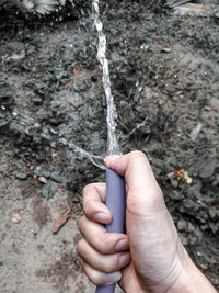 Close-up of hand holding rope