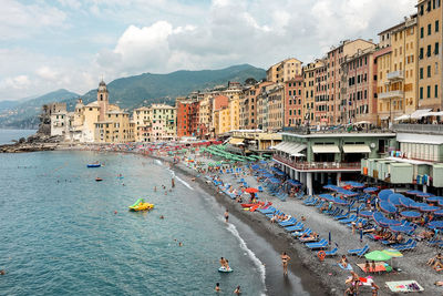 High angle view of buildings by sea against sky