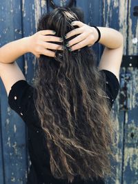 Rear view of woman with hand in hair