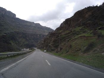 Road amidst mountains against sky