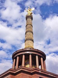 Low angle view of eiffel tower against cloudy sky