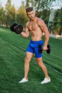 Full length of man exercising in gym