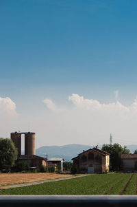 Built structure against blue sky and clouds