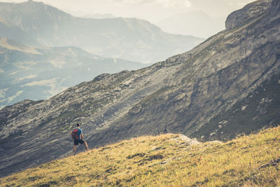 Rear view of man standing on mountain