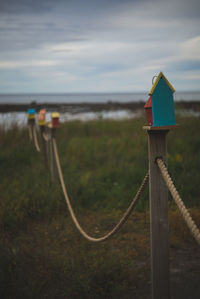 Lifeguard hut by sea against sky