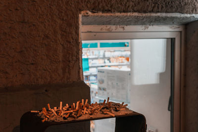 Close-up of fire on table against wall