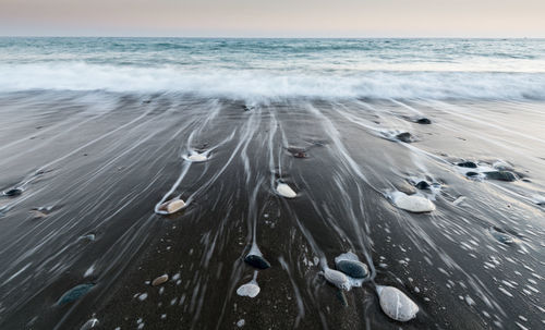 High angle view of snow on beach against sky