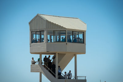 People against clear blue sky