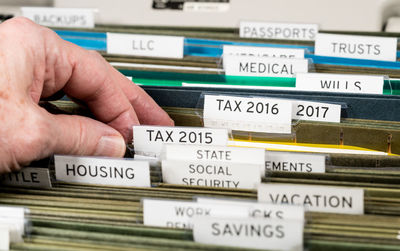 Cropped hand of man holding documents