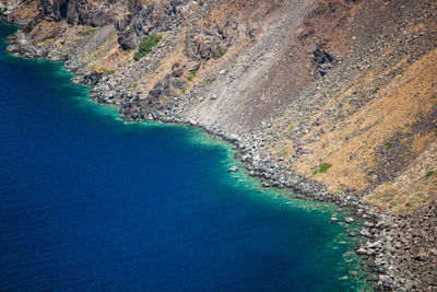 Volcanic mountains and turquoise water in santorini island, greece.